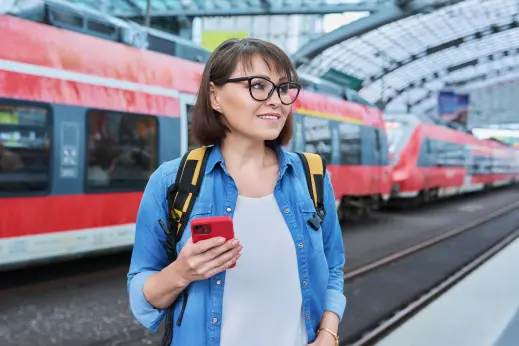 Traveller using an eSIM-enabled smartphone after arriving in a new city